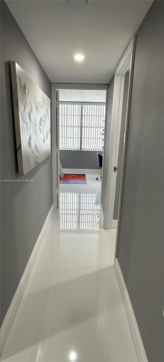 corridor featuring baseboards