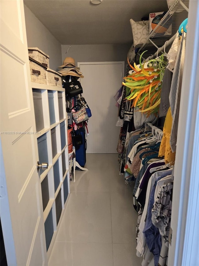 walk in closet featuring tile patterned flooring