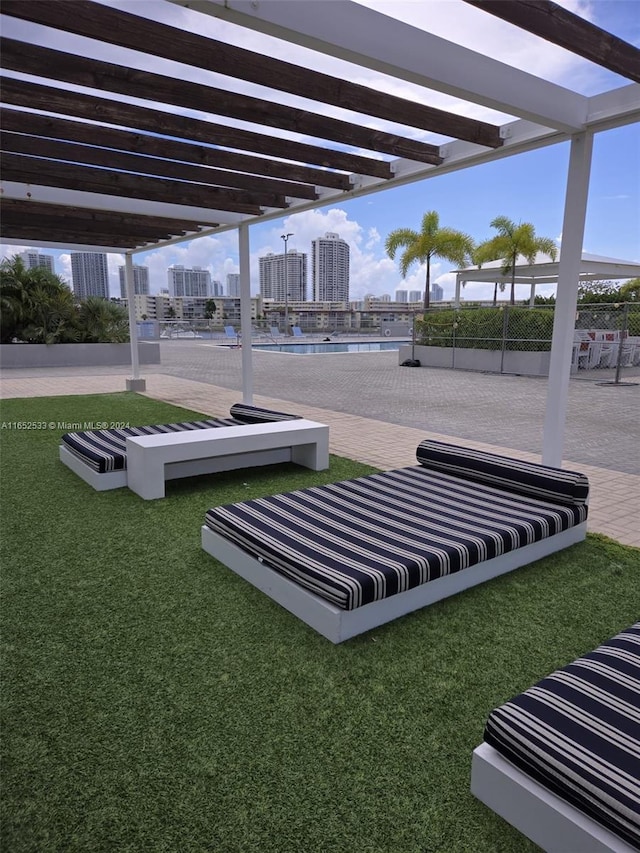 view of community featuring a yard, a view of city, and fence