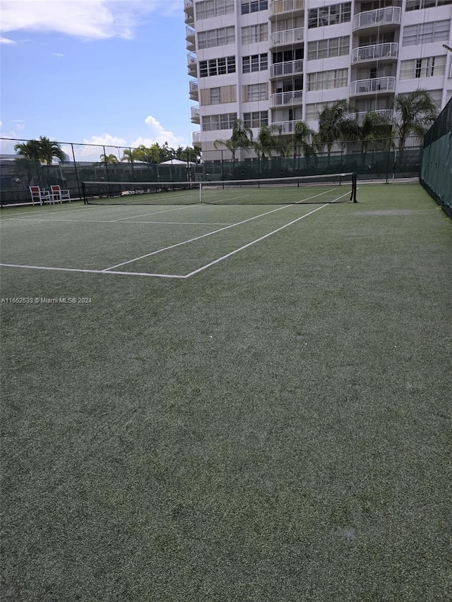 view of sport court featuring fence