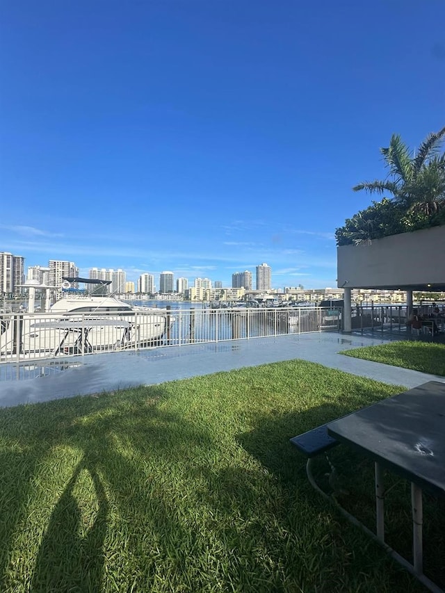 view of yard featuring a city view and a water view