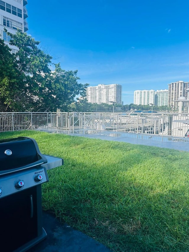 view of yard featuring fence and a city view