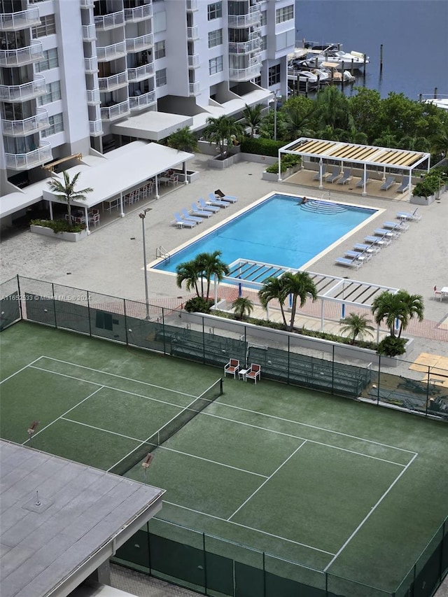 view of sport court featuring a community pool and fence