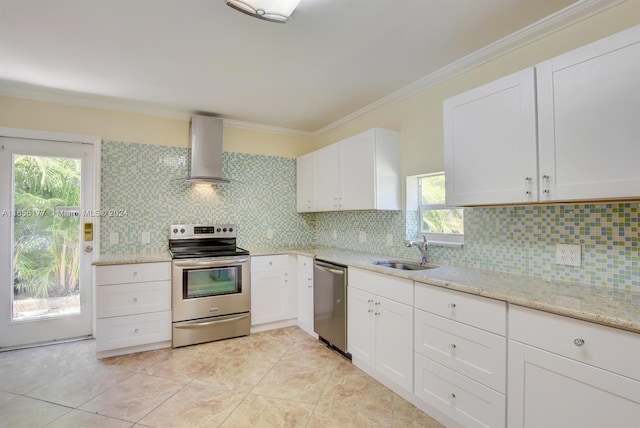 kitchen with tasteful backsplash, stainless steel appliances, sink, white cabinets, and wall chimney range hood