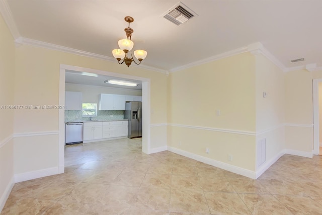 spare room with an inviting chandelier, light tile patterned flooring, and ornamental molding