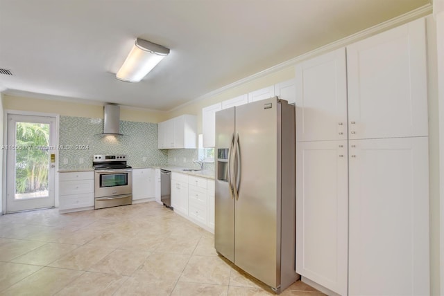 kitchen with backsplash, appliances with stainless steel finishes, white cabinetry, sink, and wall chimney exhaust hood