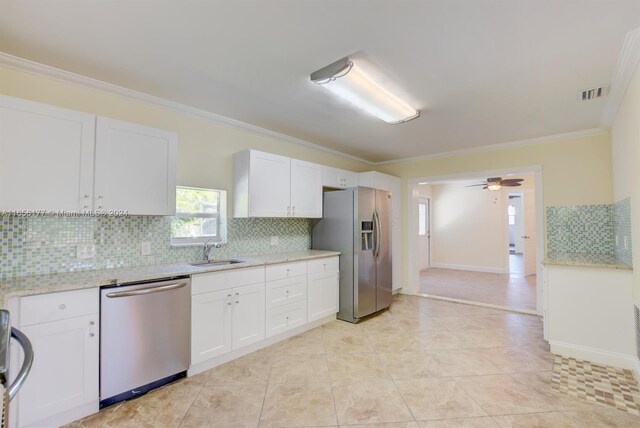 kitchen featuring stainless steel appliances, sink, ceiling fan, and white cabinets