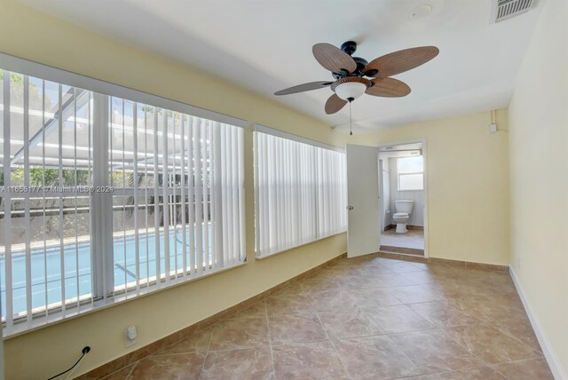 unfurnished sunroom featuring a healthy amount of sunlight and ceiling fan