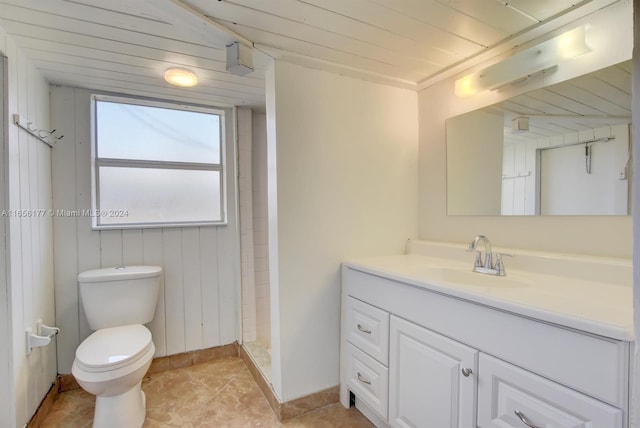 bathroom with tile patterned flooring, walk in shower, toilet, and vanity