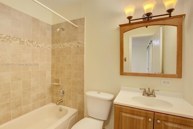 full bathroom with vanity, toilet, and tiled shower / bath combo