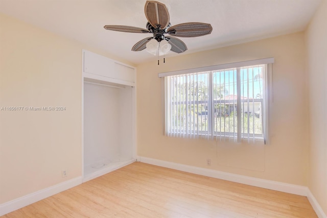 empty room with light wood-type flooring and ceiling fan