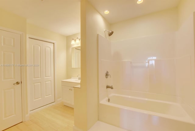 bathroom with vanity, shower / washtub combination, and hardwood / wood-style flooring