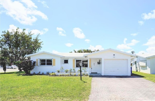 ranch-style house with a garage and a front lawn