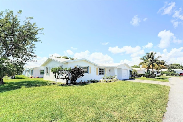 view of property exterior with a yard and a garage