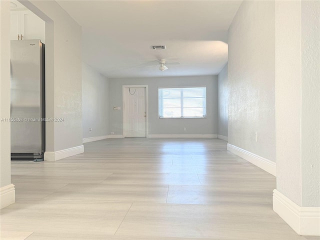 spare room featuring ceiling fan and light hardwood / wood-style flooring