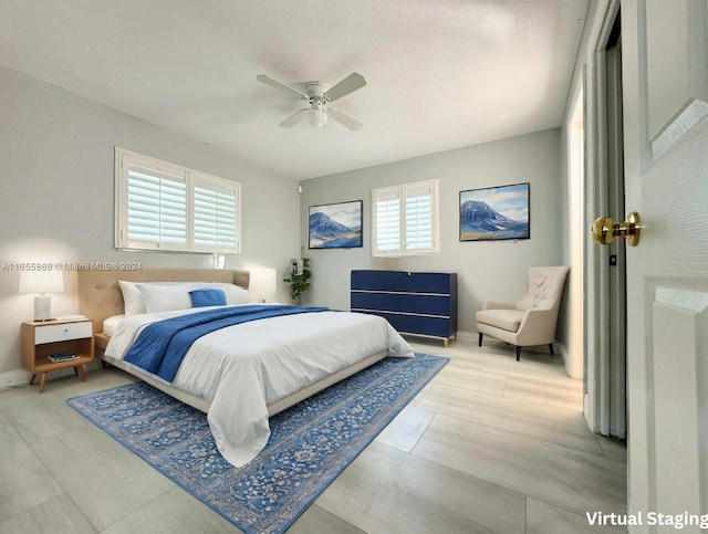 bedroom with ceiling fan and light hardwood / wood-style floors