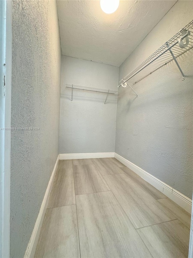 walk in closet featuring hardwood / wood-style floors