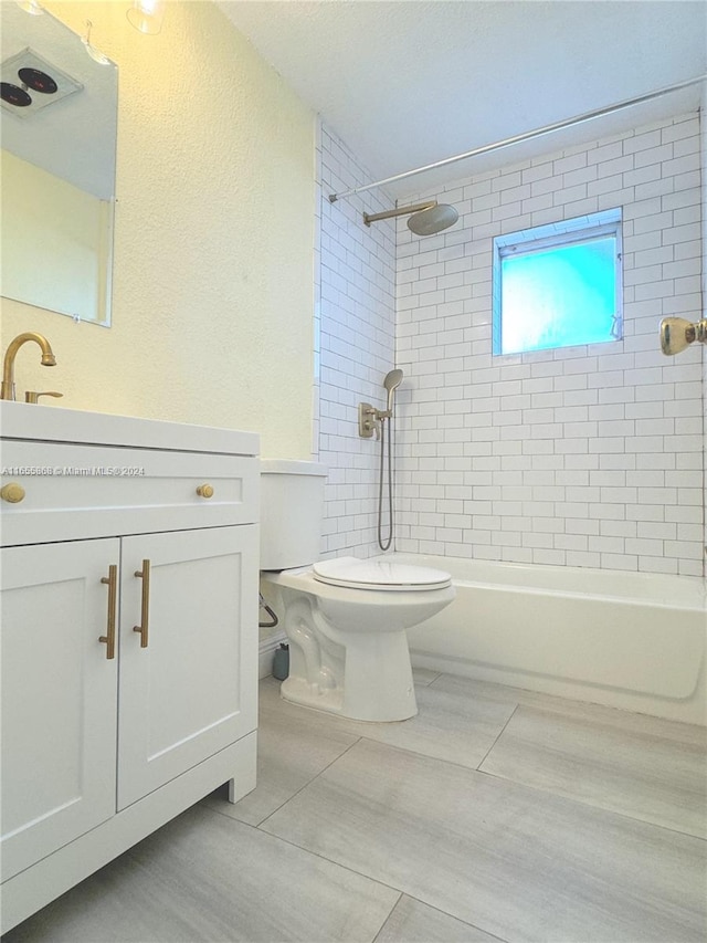 full bathroom featuring vanity, toilet, and tiled shower / bath