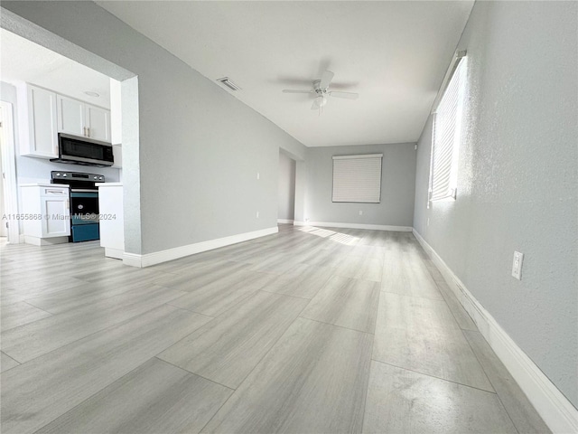 unfurnished living room featuring ceiling fan