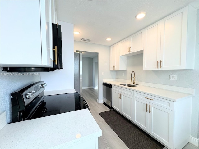 kitchen featuring light wood-type flooring, sink, electric range, stainless steel dishwasher, and white cabinets