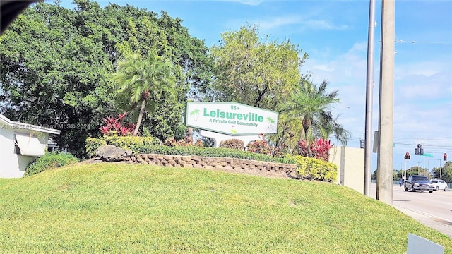 community / neighborhood sign with a lawn