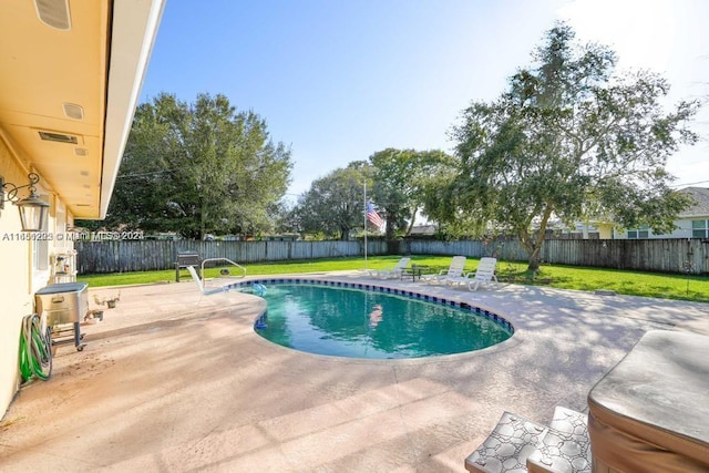 view of swimming pool with a lawn and a patio area