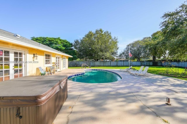 view of pool featuring a patio, a hot tub, and a yard