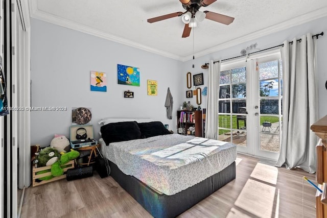 bedroom with ceiling fan, access to outside, ornamental molding, a textured ceiling, and hardwood / wood-style flooring