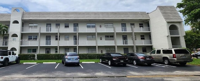 view of building exterior with uncovered parking