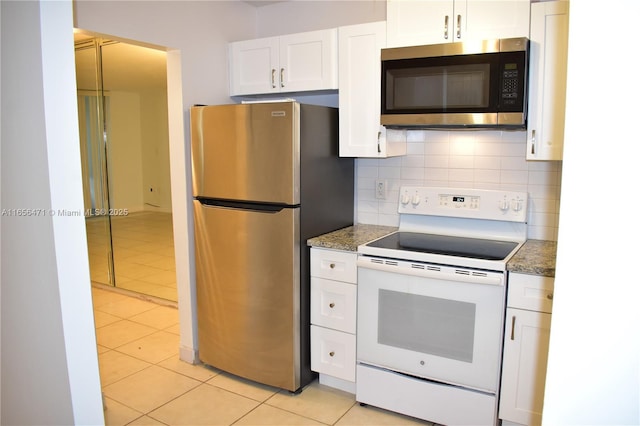 kitchen with tasteful backsplash, light tile patterned floors, white cabinets, and stainless steel appliances