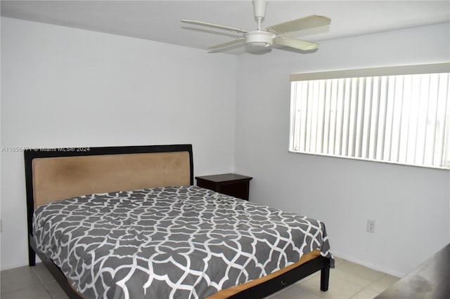 tiled bedroom with ceiling fan