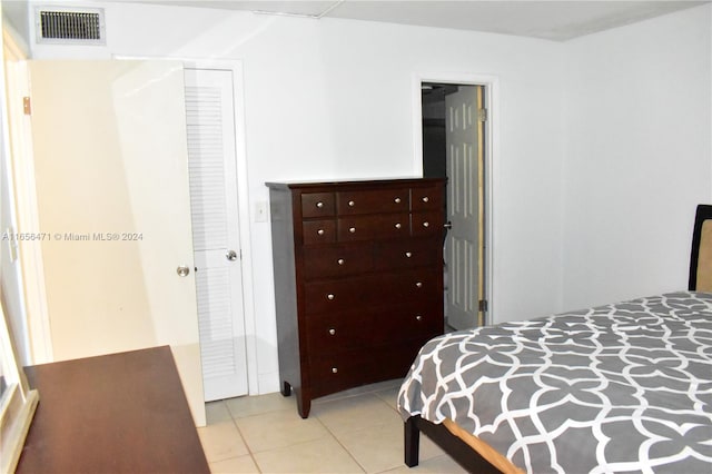 bedroom featuring a closet and light tile patterned flooring