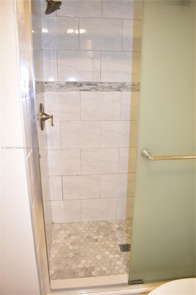 bathroom with a shower with shower door