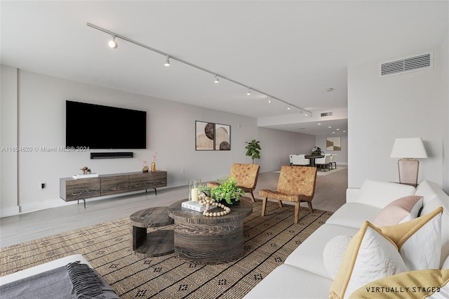 living room featuring track lighting and hardwood / wood-style flooring