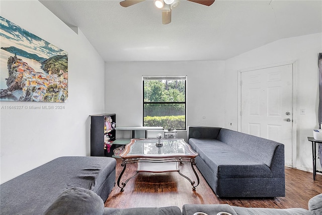 living room featuring a textured ceiling, ceiling fan, hardwood / wood-style floors, and vaulted ceiling