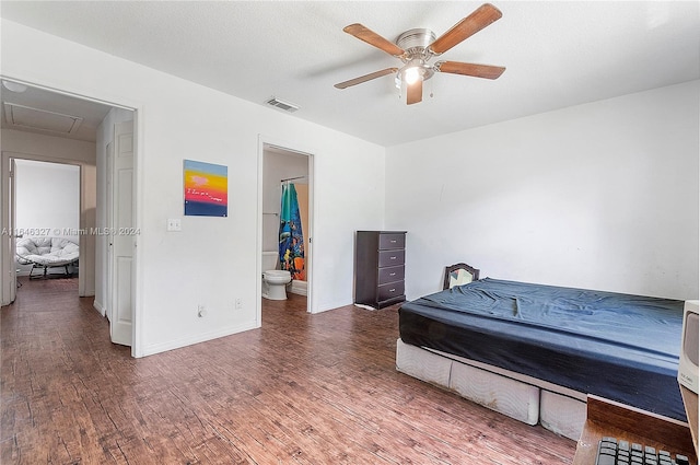 bedroom featuring ensuite bath, a textured ceiling, ceiling fan, and dark hardwood / wood-style floors