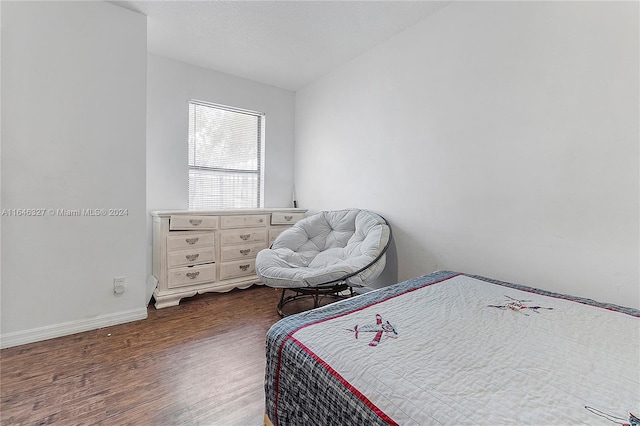 bedroom with dark wood-type flooring