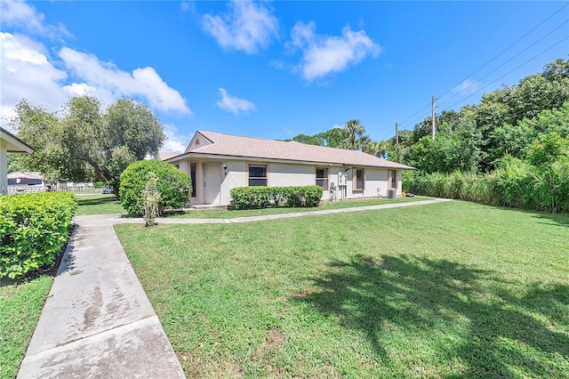 ranch-style house with a front lawn