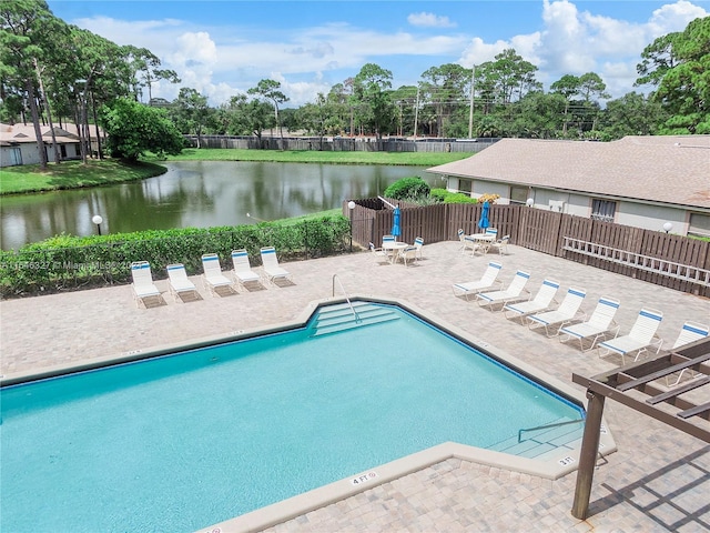 view of swimming pool featuring a patio area and a water view