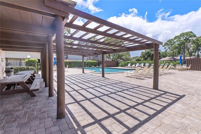 view of patio / terrace featuring a pergola and a community pool