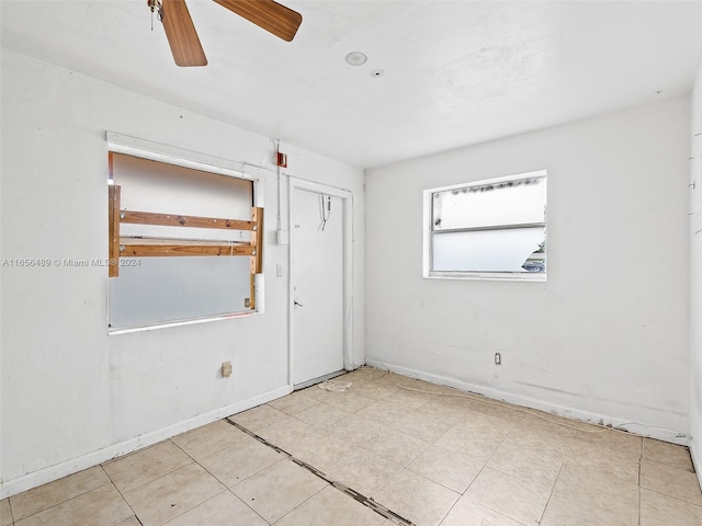 spare room featuring ceiling fan and light tile patterned flooring