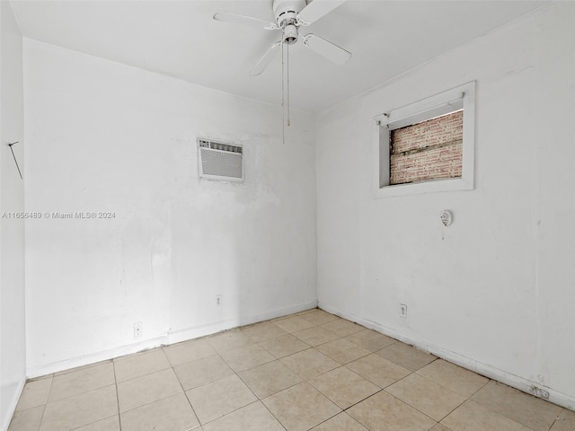 tiled spare room with ceiling fan and a wall unit AC