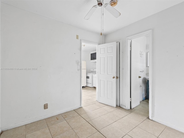 spare room with light tile patterned floors, baseboards, and ceiling fan