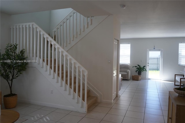 staircase with tile patterned floors