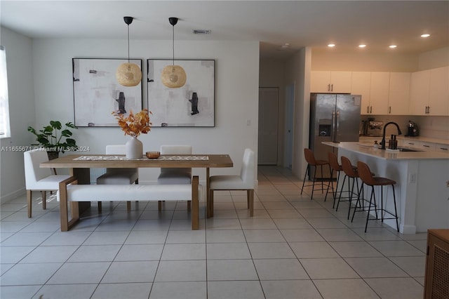 tiled dining space featuring sink