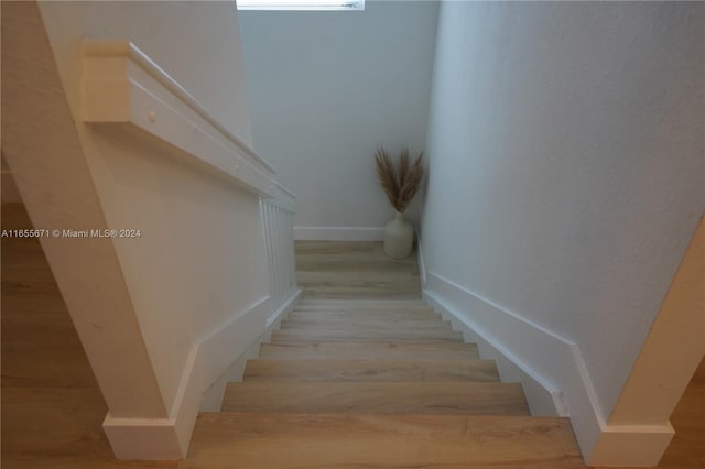 stairs with hardwood / wood-style floors