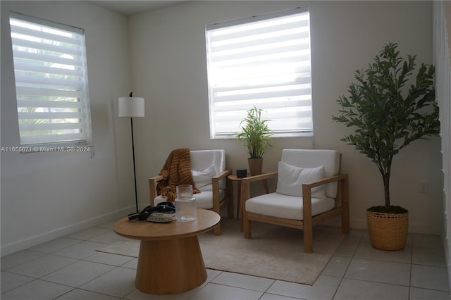 living area with a healthy amount of sunlight and light tile patterned floors