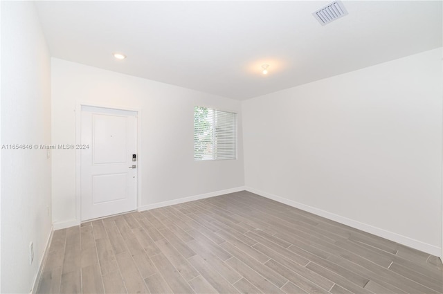 unfurnished room with light hardwood / wood-style floors