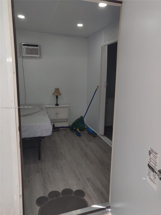 interior space featuring hardwood / wood-style floors and a wall unit AC