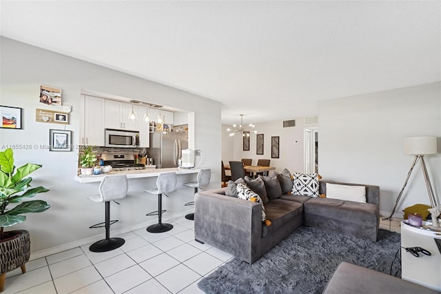 living room with an inviting chandelier and light tile patterned floors